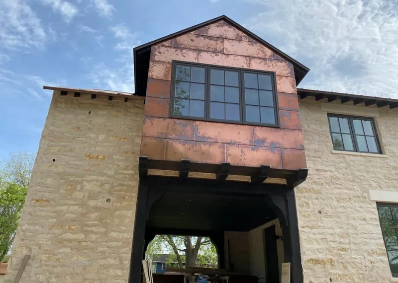 Copper metal panel facade on a stone building for Metal Roof Coating in Nevada